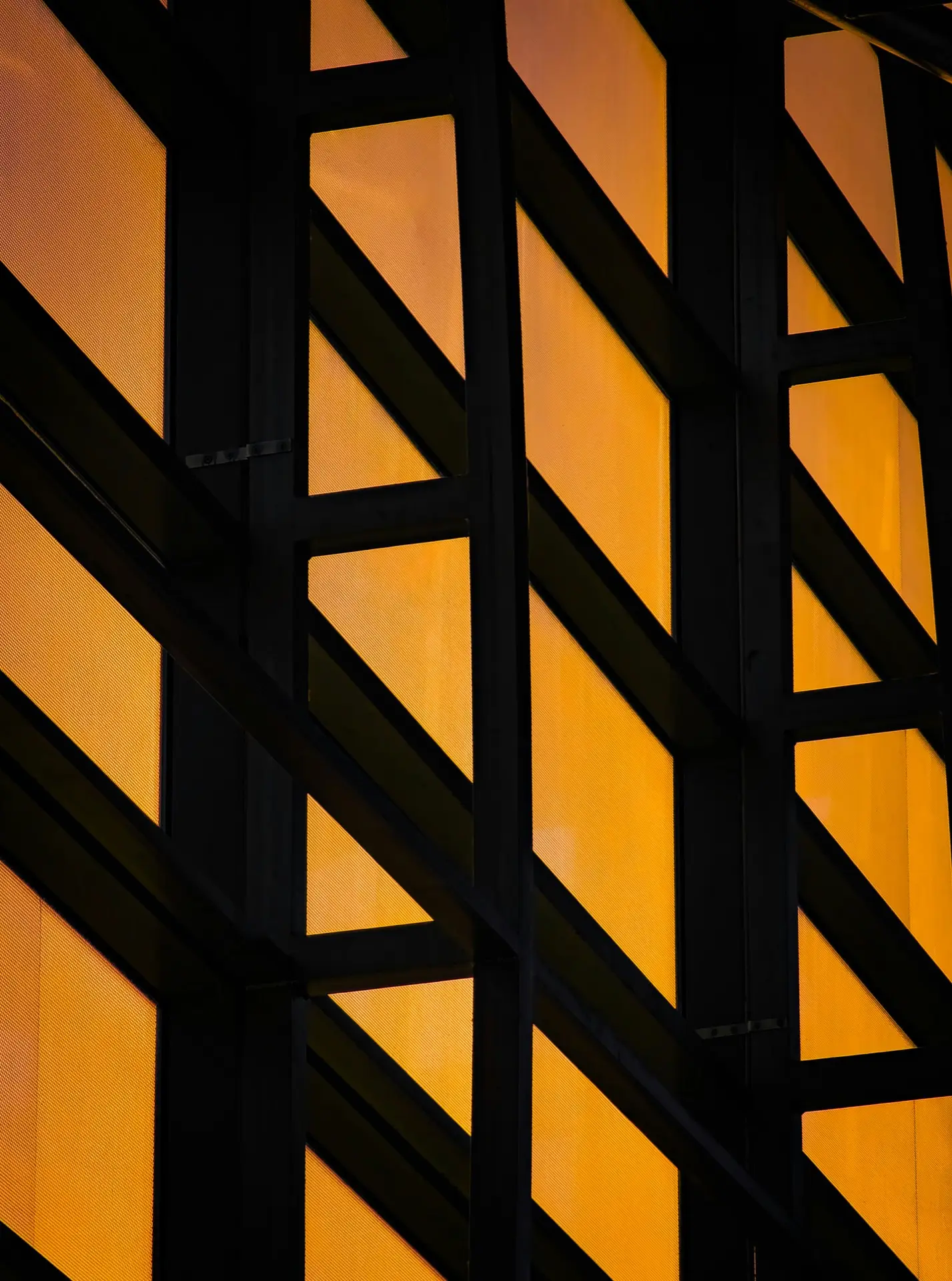 Golden facade panels with black diagonal beams - modern architecture